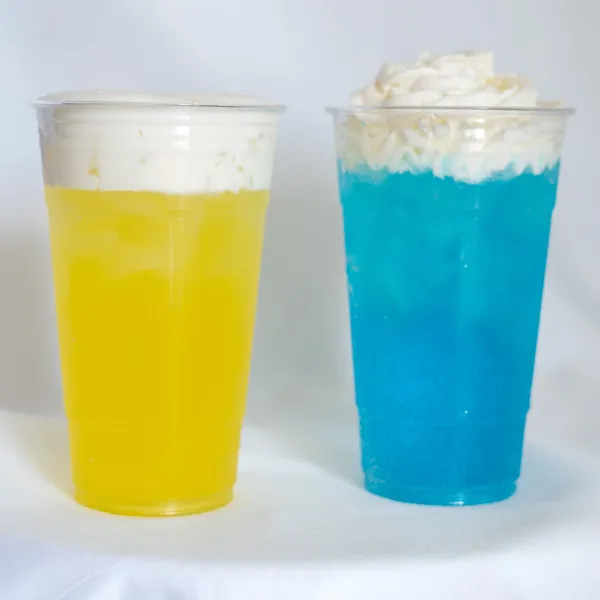 Two cream-topped sodas, one yellow and one blue